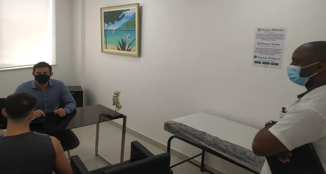 Médico, fisioterapeuta e paciente inteirados no atendimento